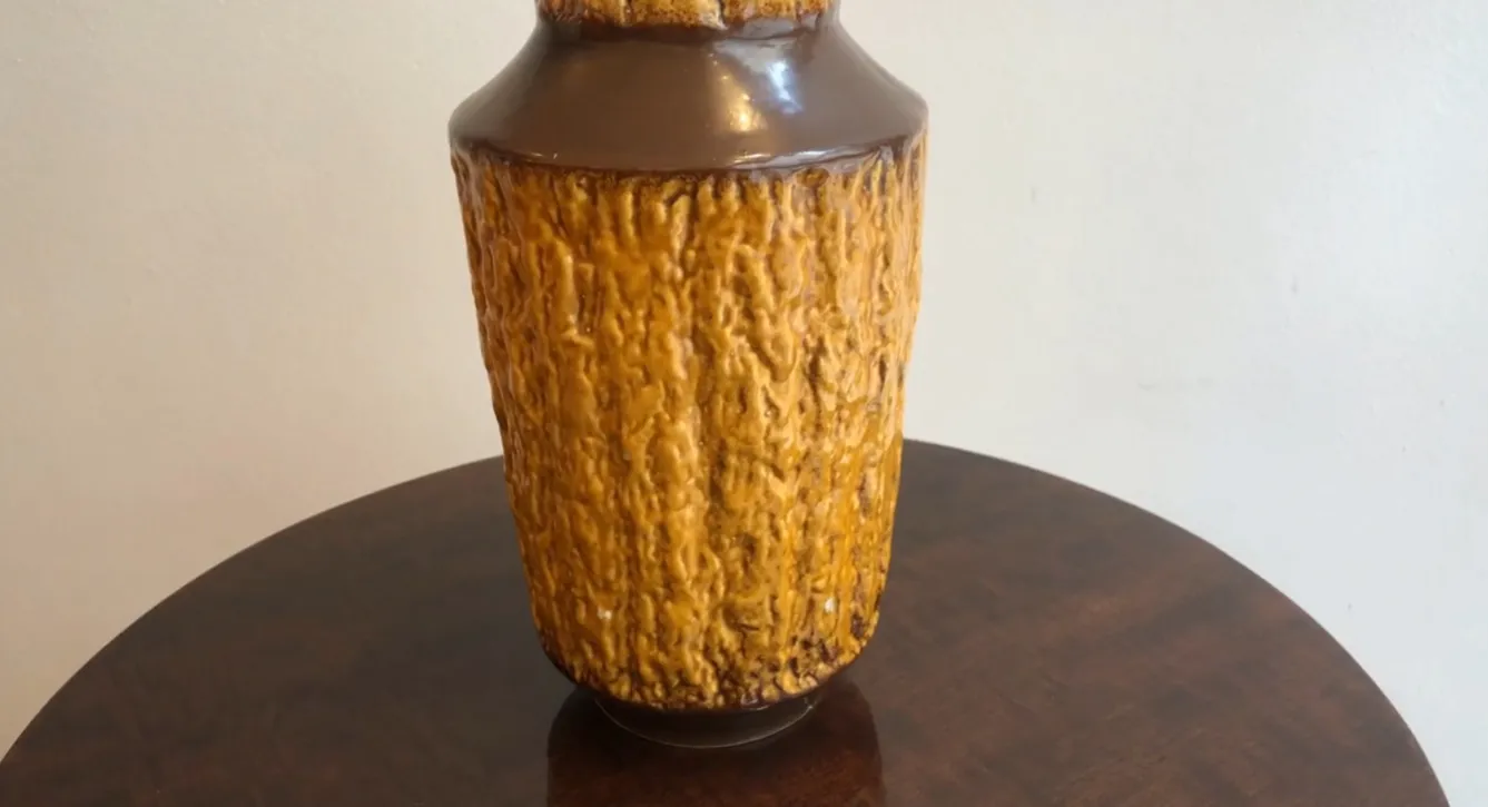 Antique ceramic vase from Carstens Tönnieshof with textured surface and brown-golden hues.