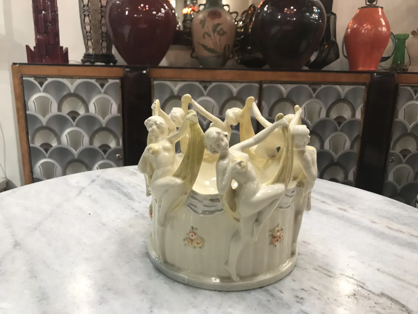 Antique ceramic featuring dancing women figures with decorative background