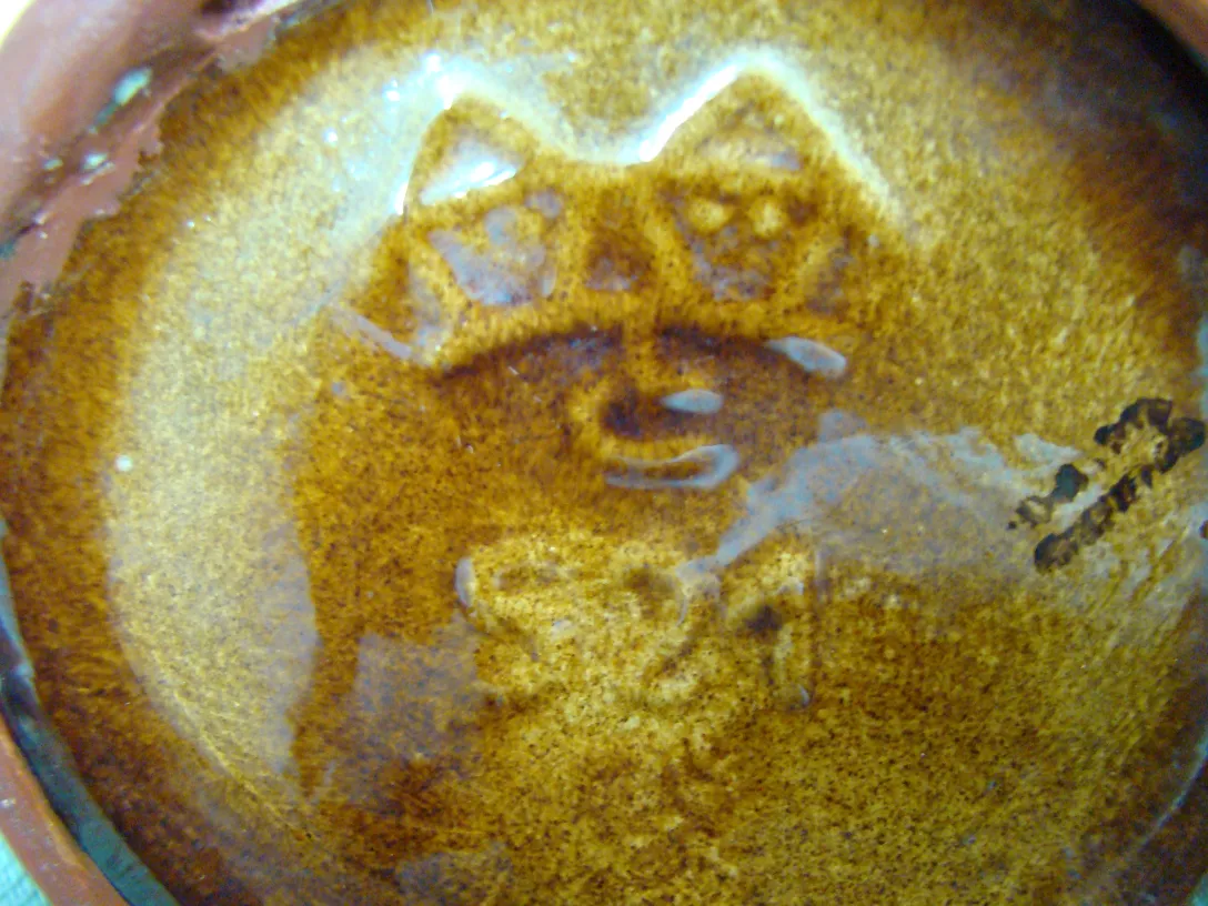 Antique ceramic with a shiny brown background and unique design by Carstens Tönnieshof.
