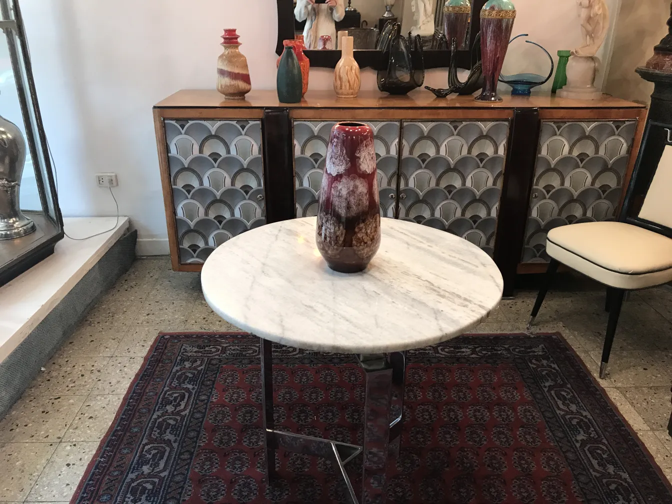 Antique ceramic vase with reddish tones set in a retro environment.