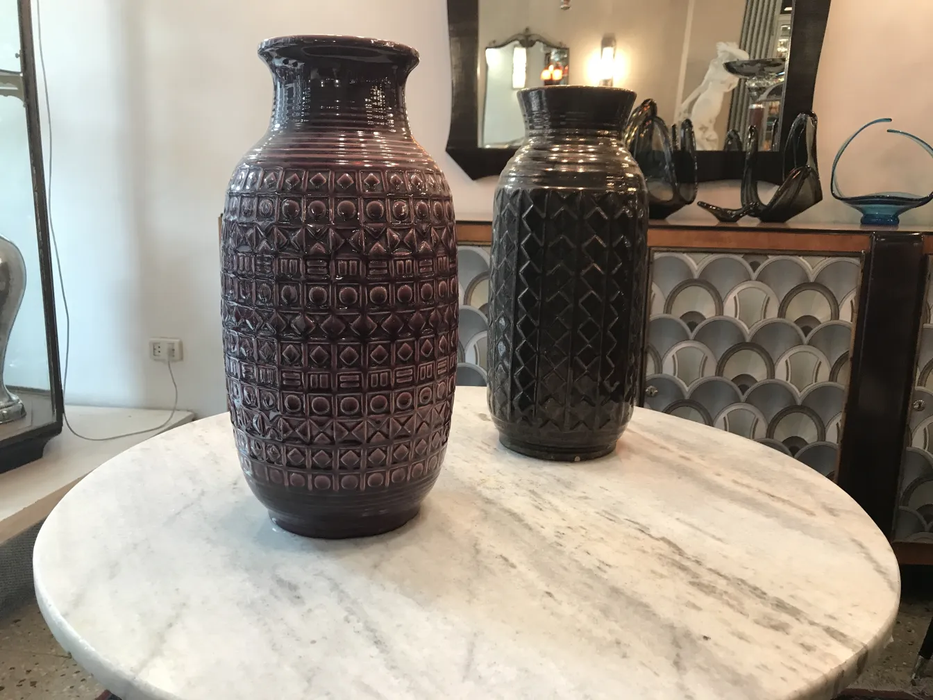 Two antique ceramic vases on a marble table