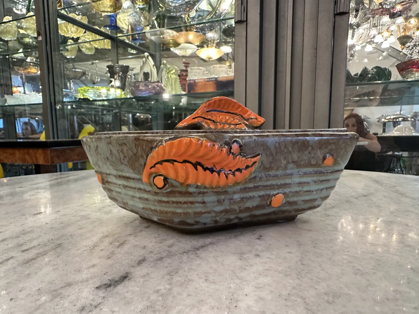 Ceramica antigua decorada con hojas en tonos naranja y marrón