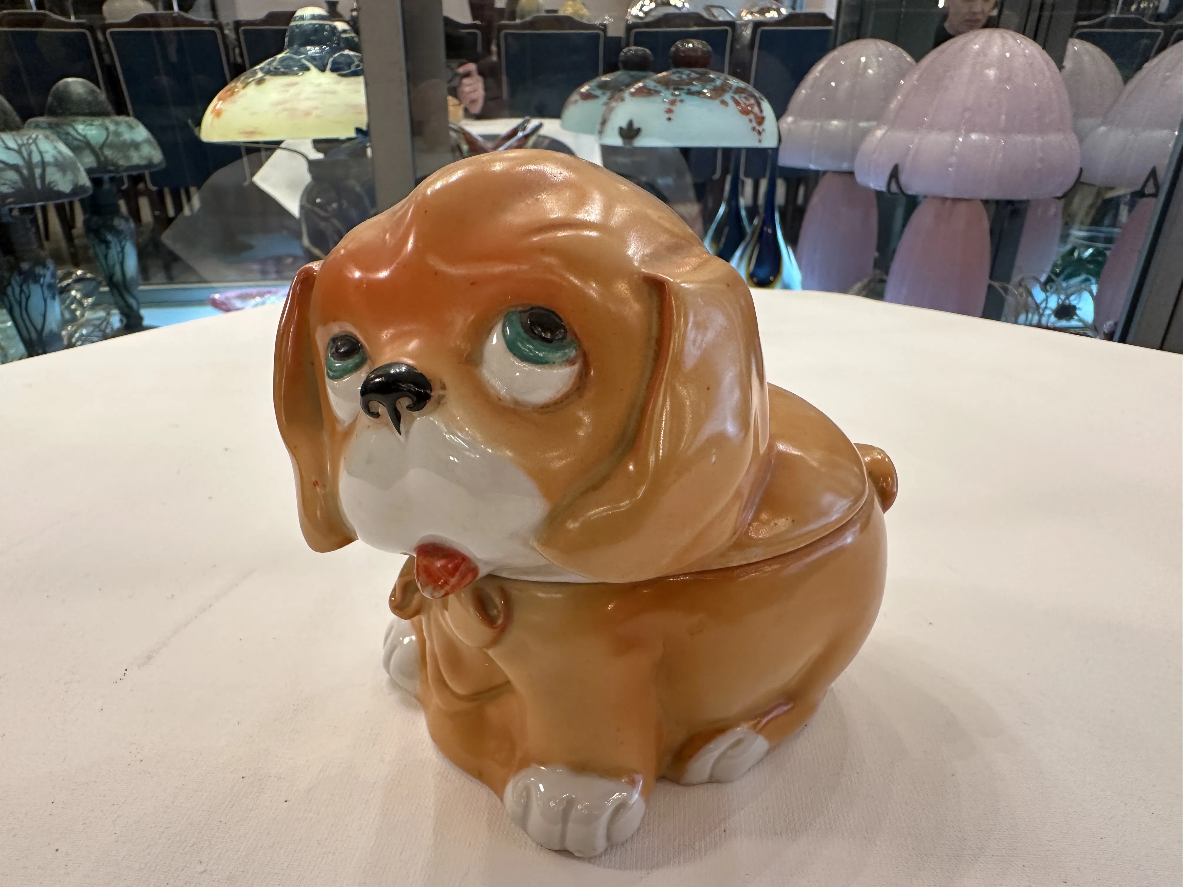 Figura antiga de cerâmica em forma de cachorro marrom claro.