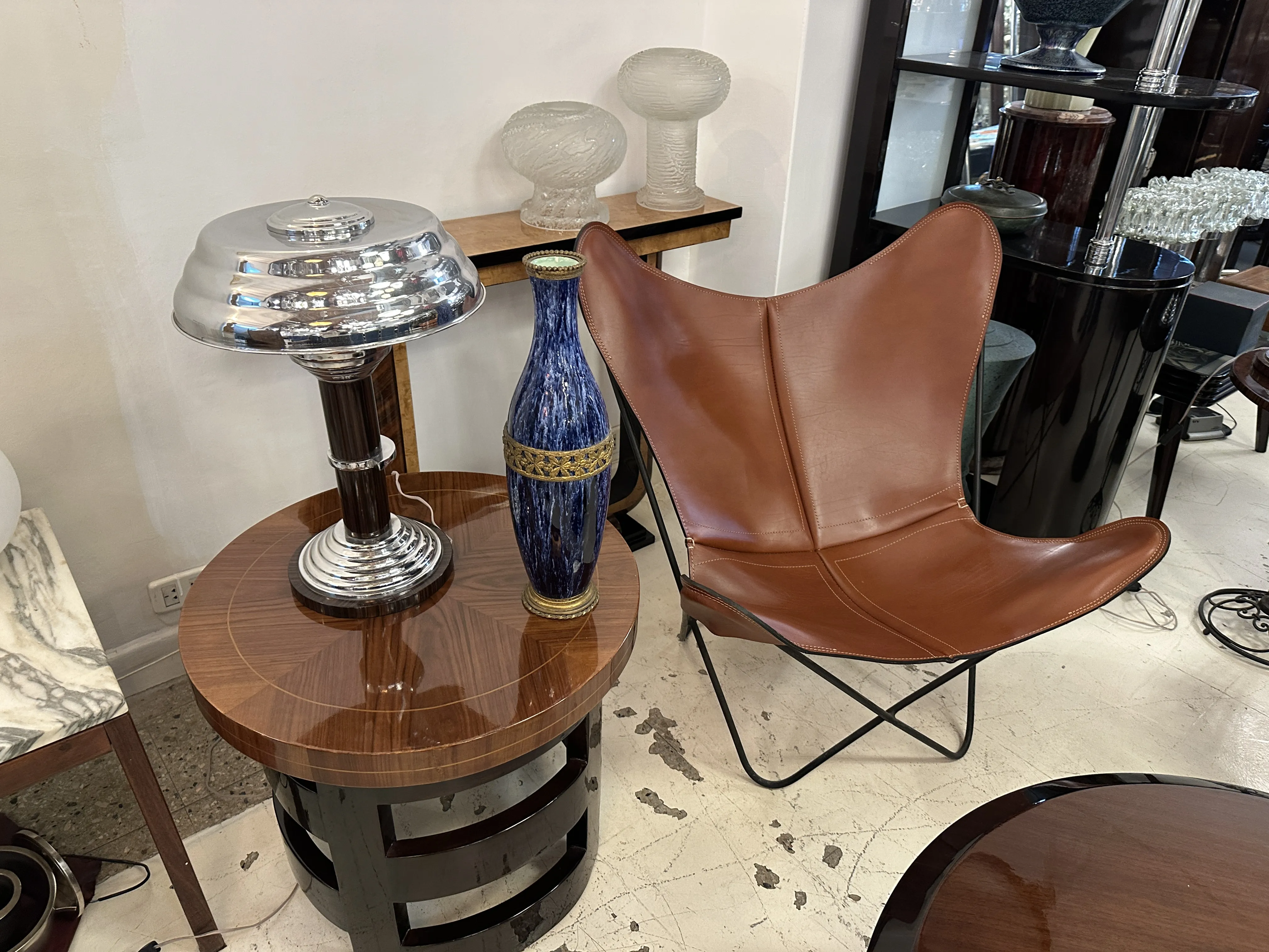 Ceramica antica di Boch Frères mostrata con lampada e sedia in pelle.