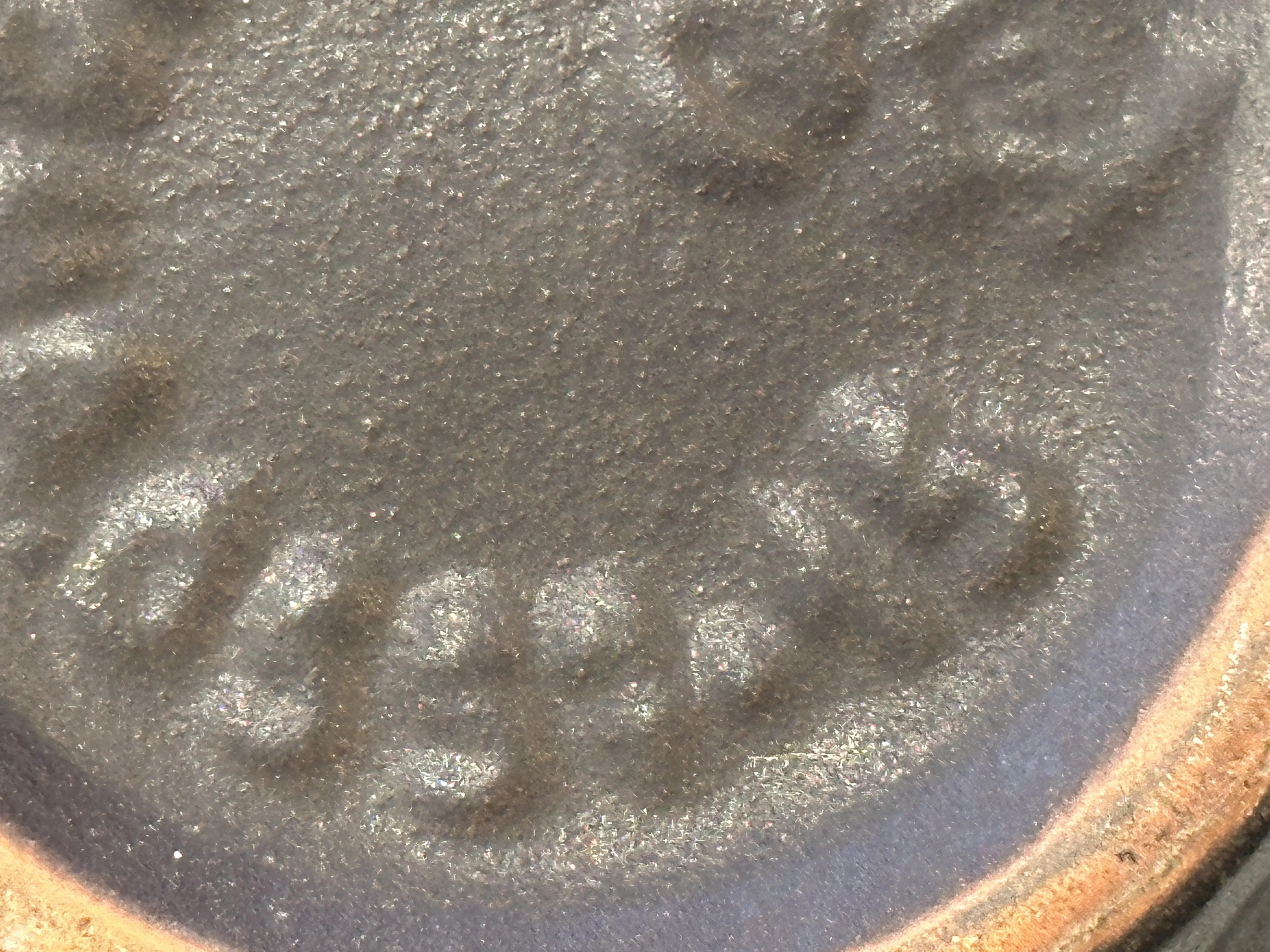 close-up of antique ceramic with shine, visible inscription