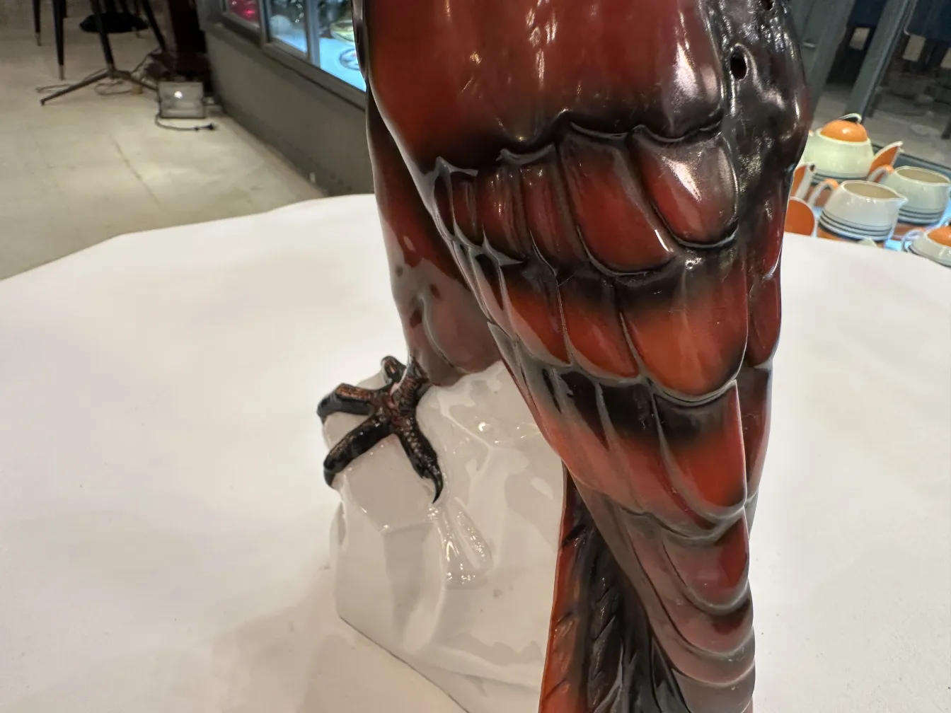 Figurilla antigua de cerámica en forma de ave, con detalles brillantes y expresivos.