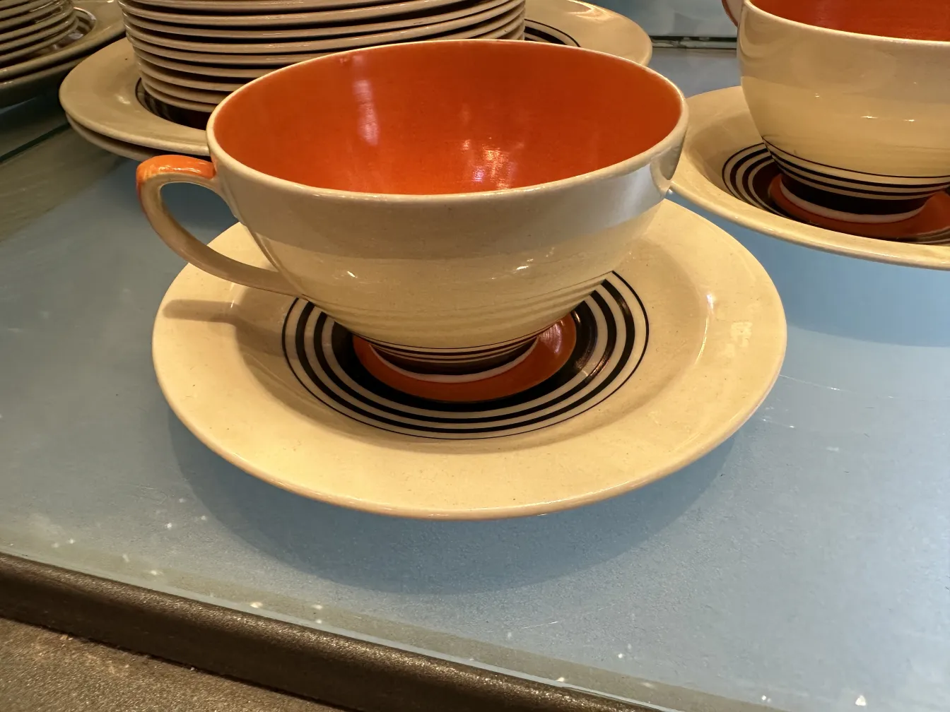 Antique tea set by Susie Cooper with colorful plates and cups