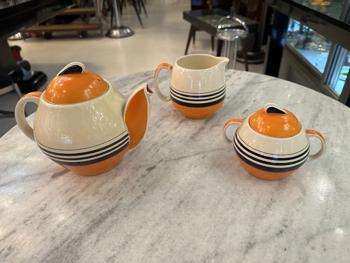 Antique tea set by Susie Cooper with colorful plates and cups