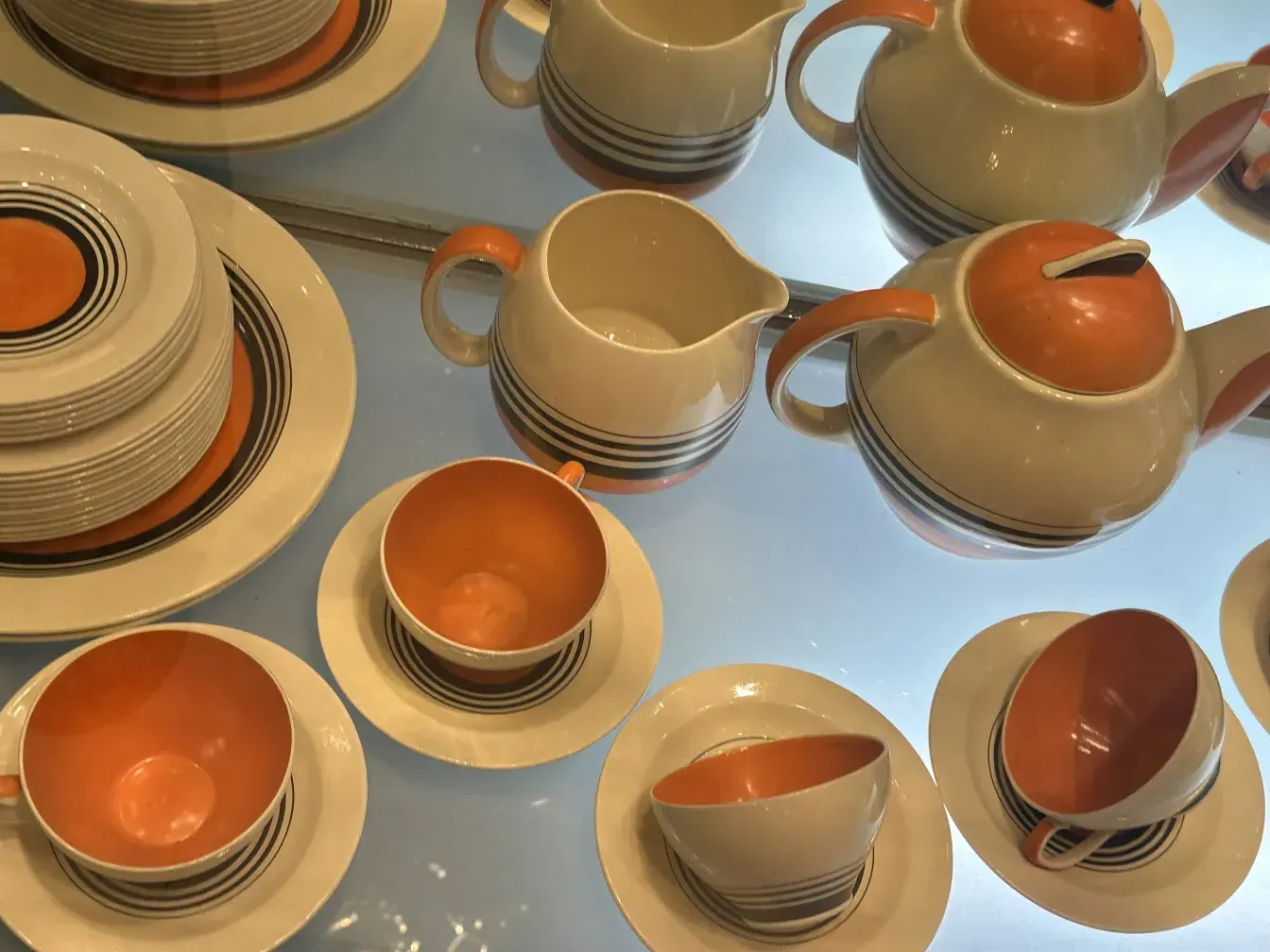 Antique tea set by Susie Cooper with colorful plates and cups