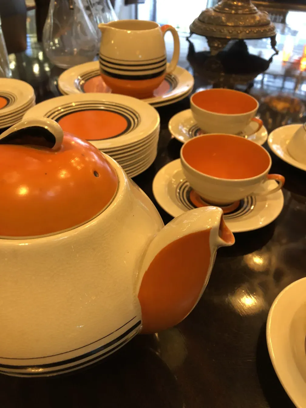 Antique tea set by Susie Cooper with colorful plates and cups