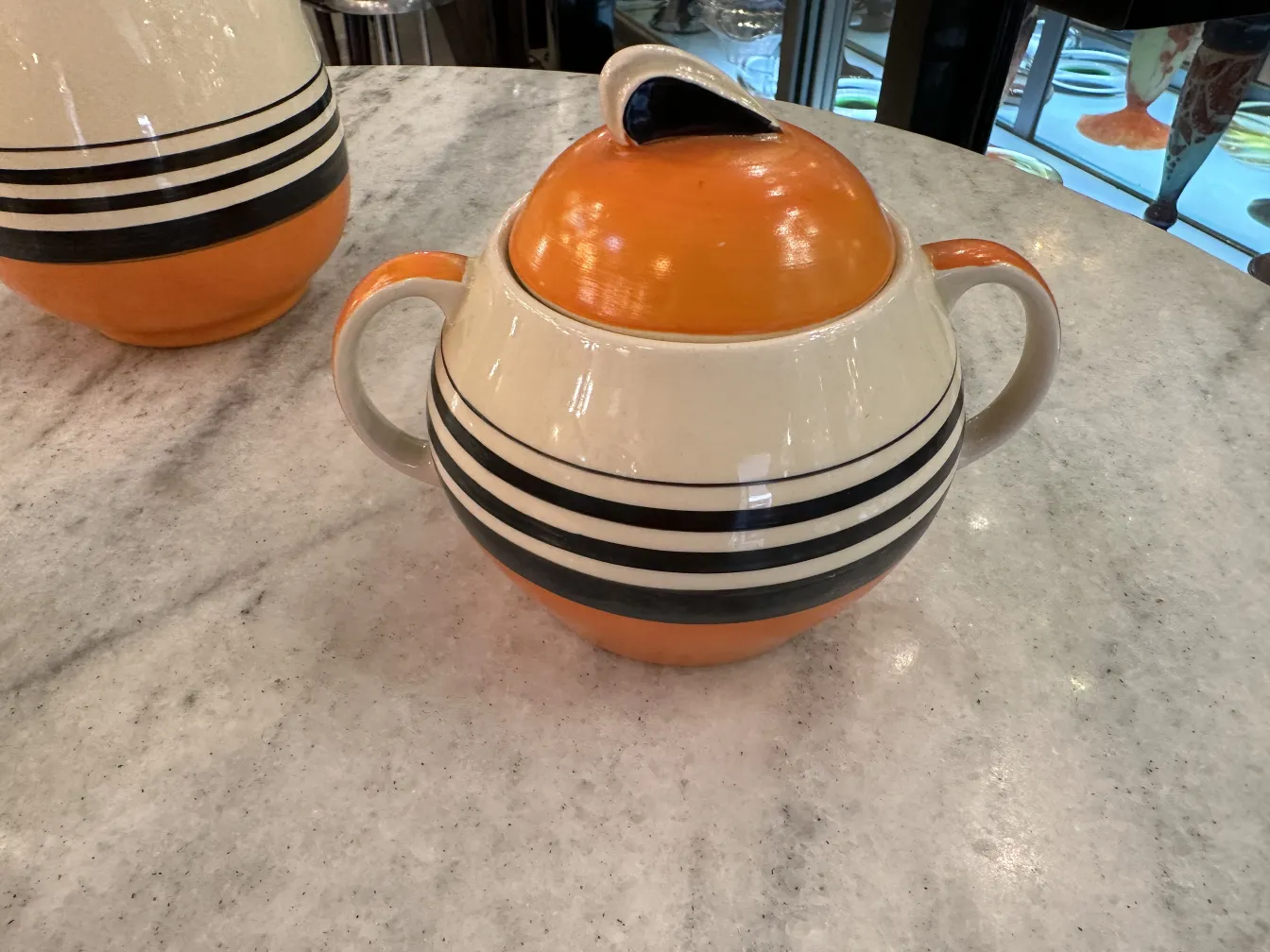 Antique tea set by Susie Cooper with colorful plates and cups