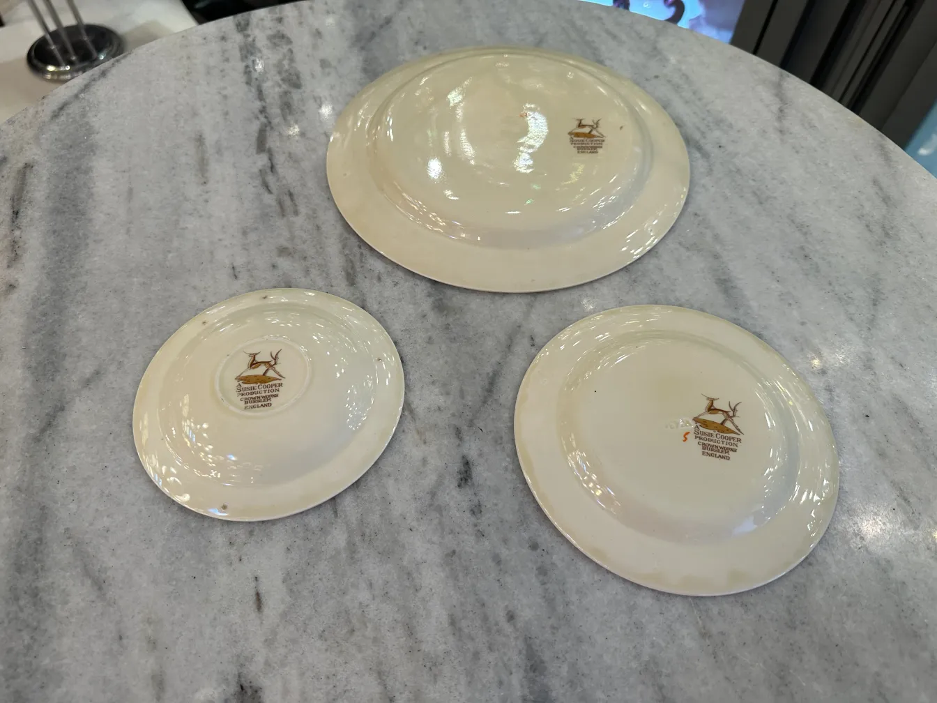 Antique tea set by Susie Cooper with colorful plates and cups