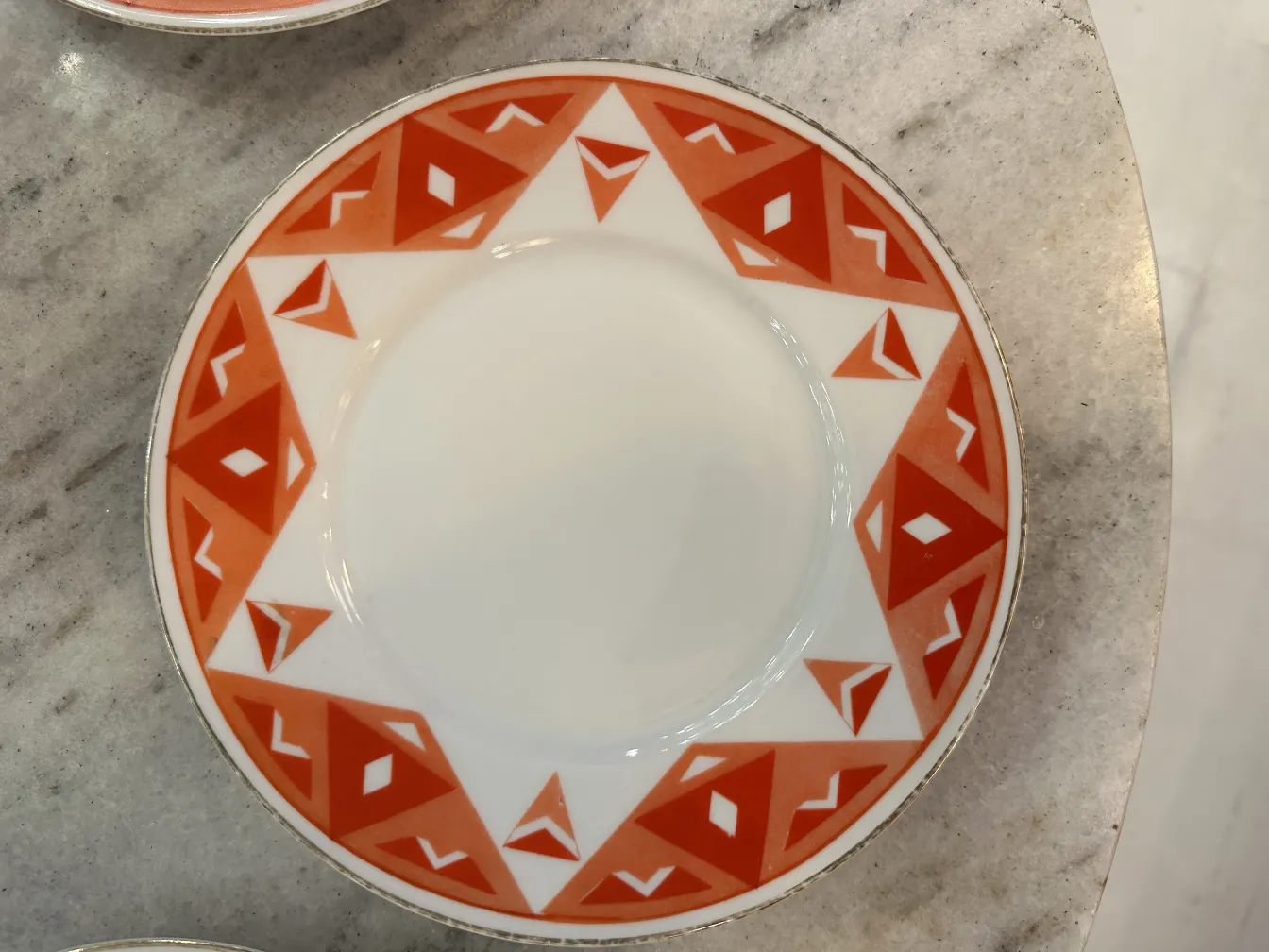 Antique tea set Volkstedt with colorful patterns on the table.