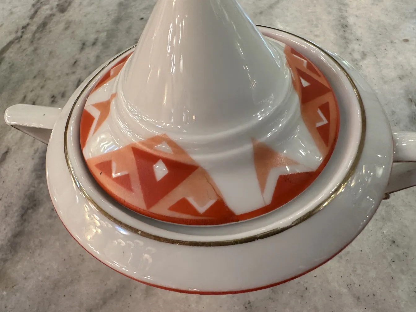 Antique tea set Volkstedt with colorful patterns on the table.