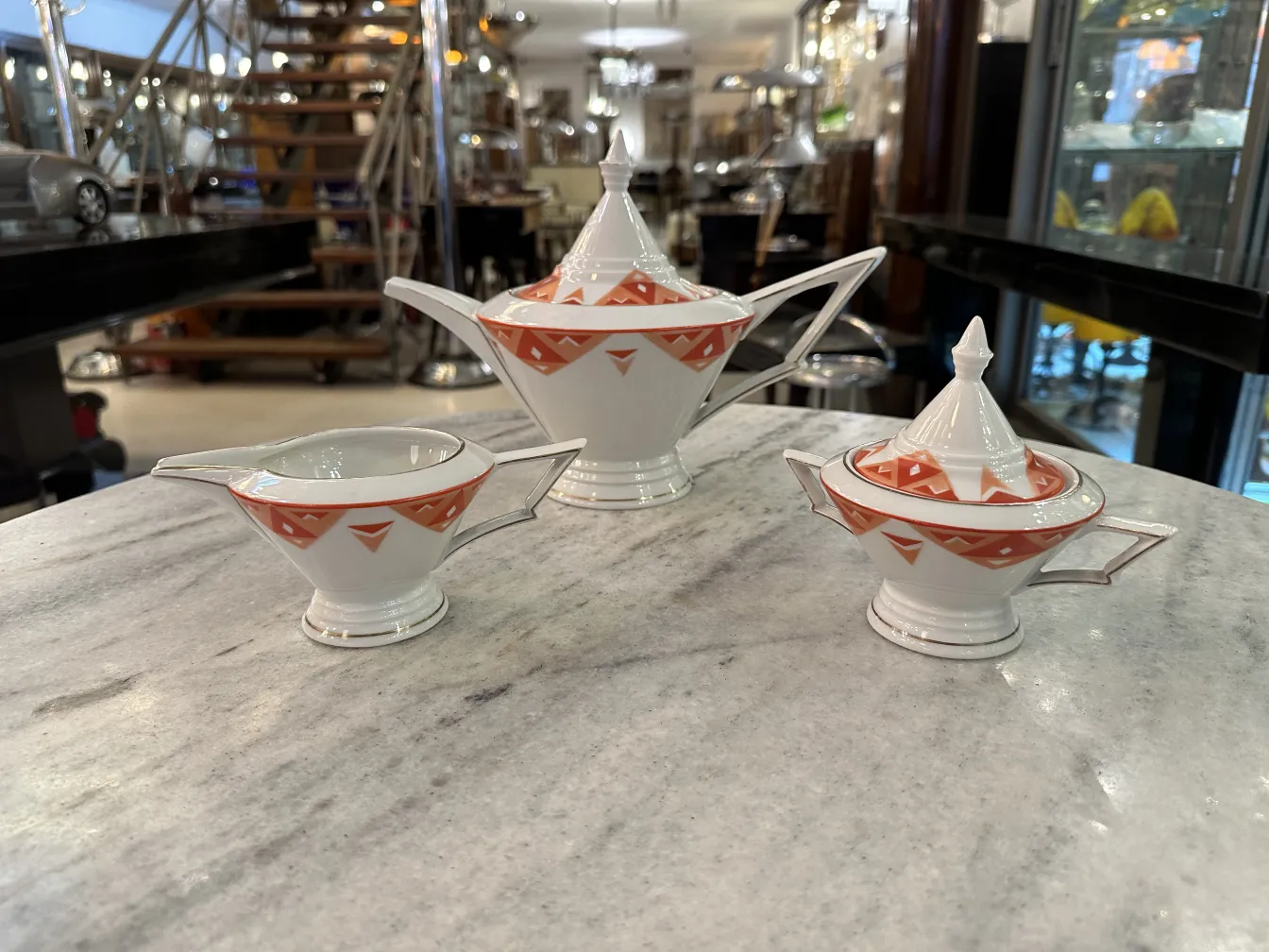 Antique tea set Volkstedt with colorful patterns on the table.