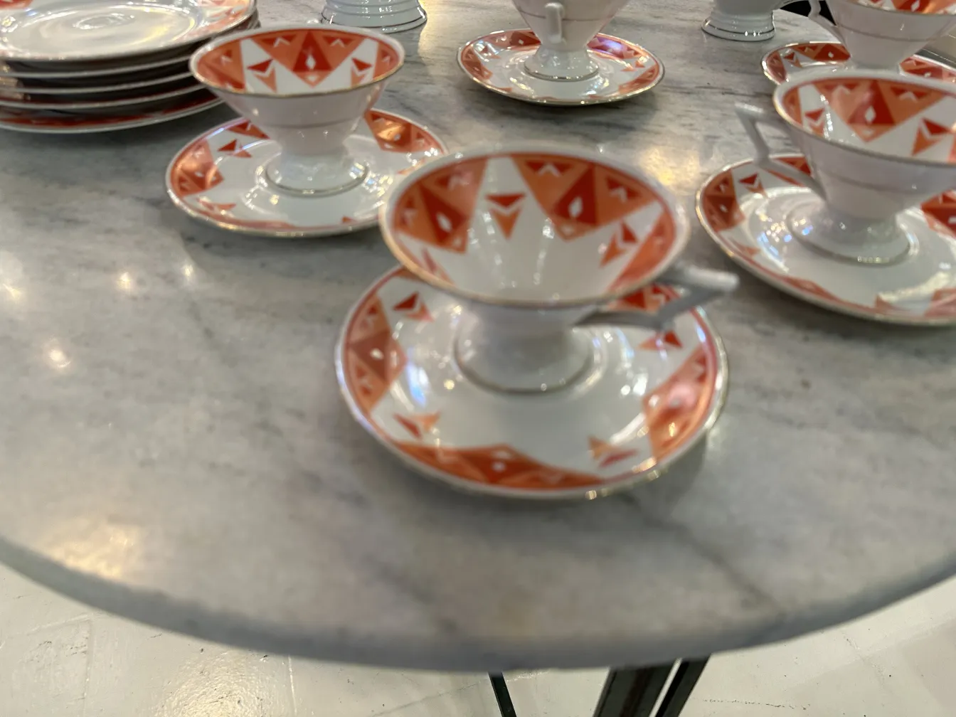 Antique tea set Volkstedt with colorful patterns on the table.