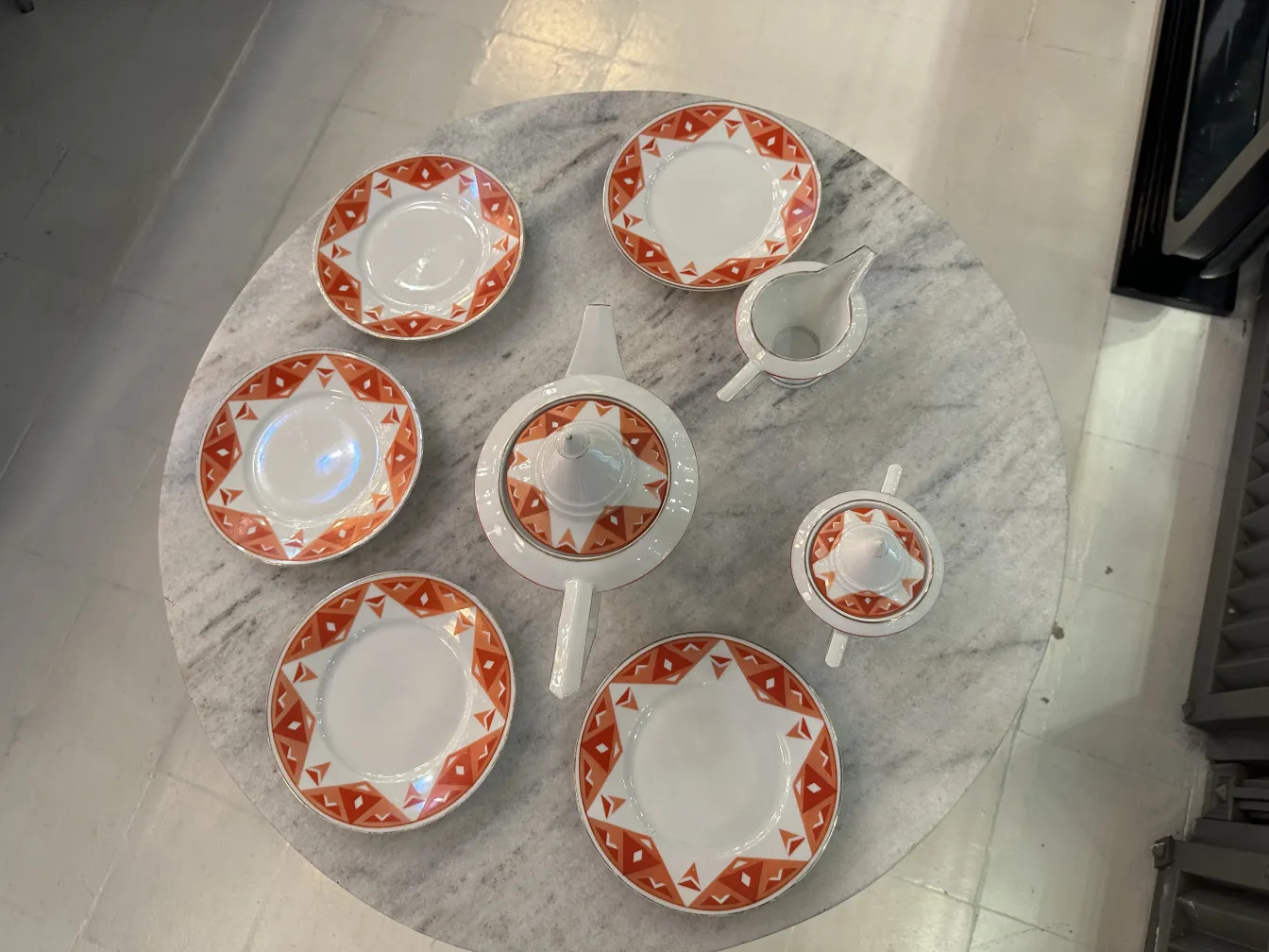Antique tea set Volkstedt with colorful patterns on the table.