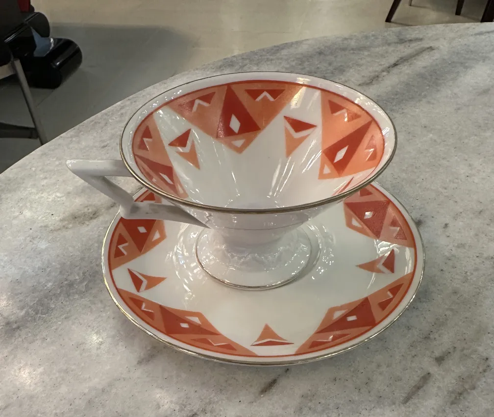 Antique tea set Volkstedt with colorful patterns on the table.