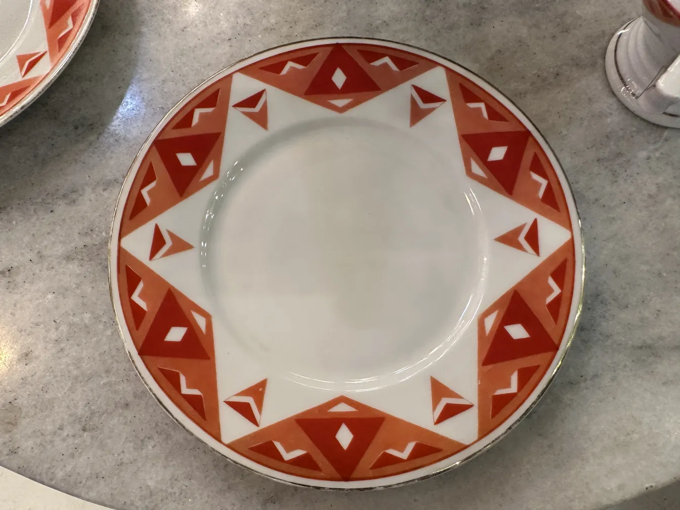 Antique tea set Volkstedt with colorful patterns on the table.