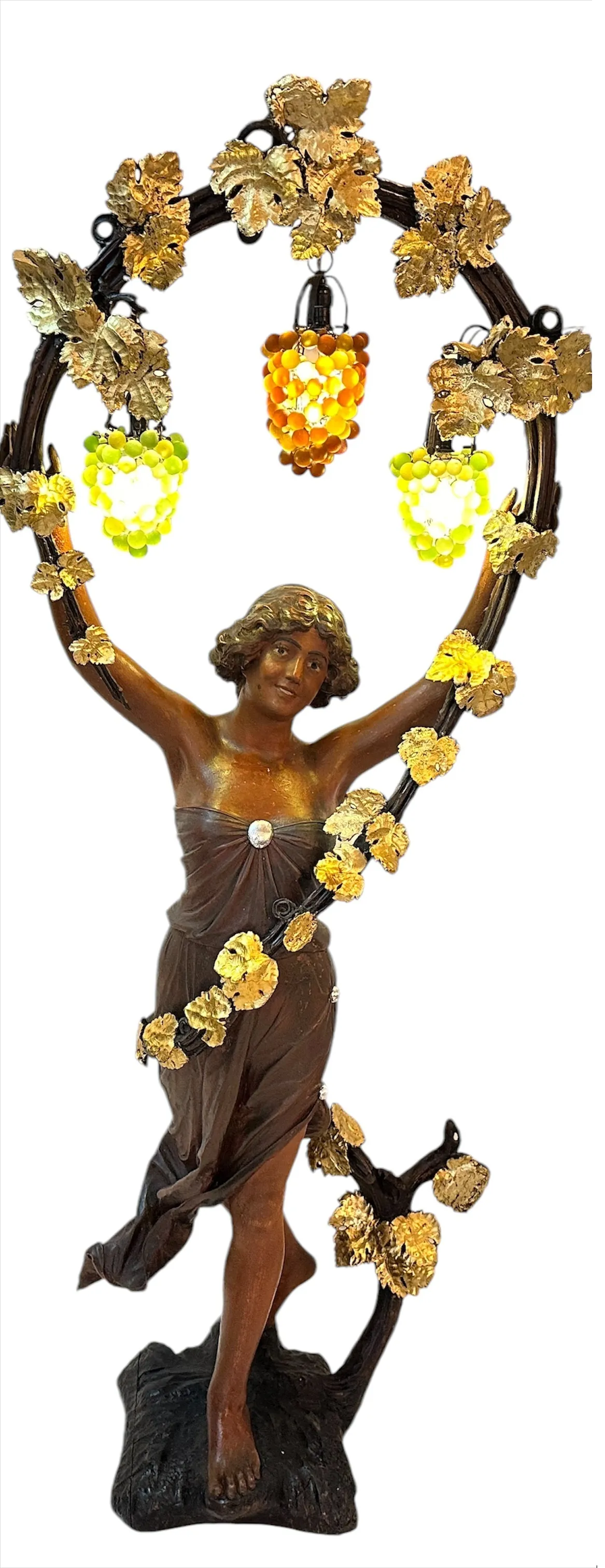 antique sculpture of woman holding colorful grapes