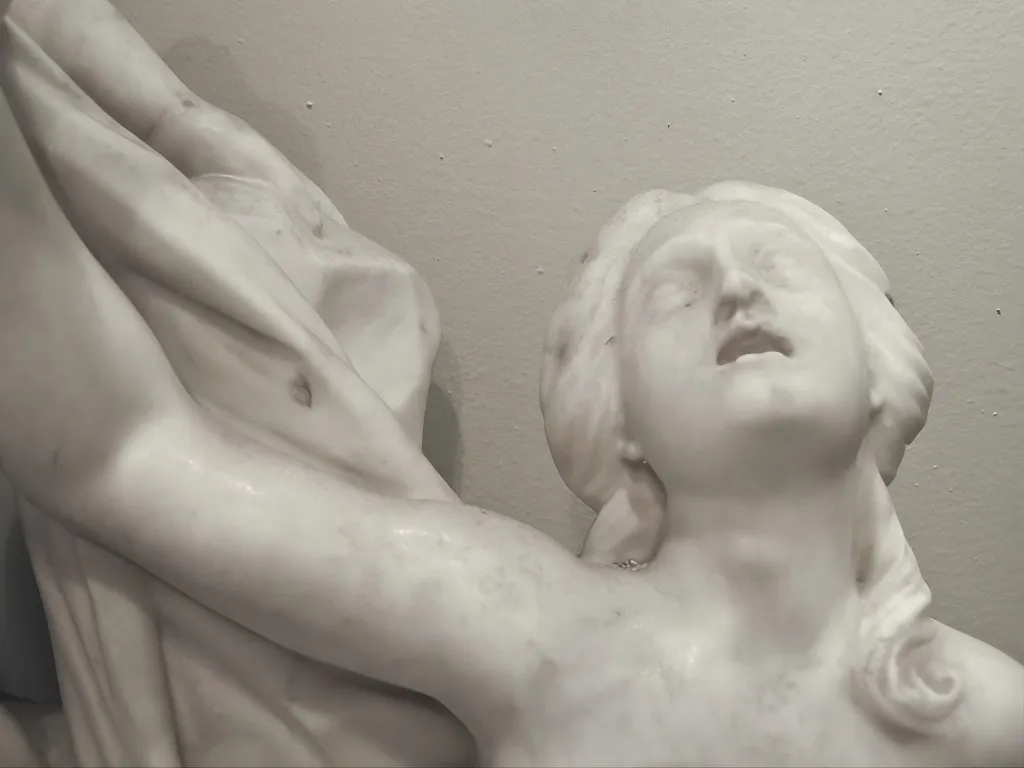 antique sculpture of two human figures in action