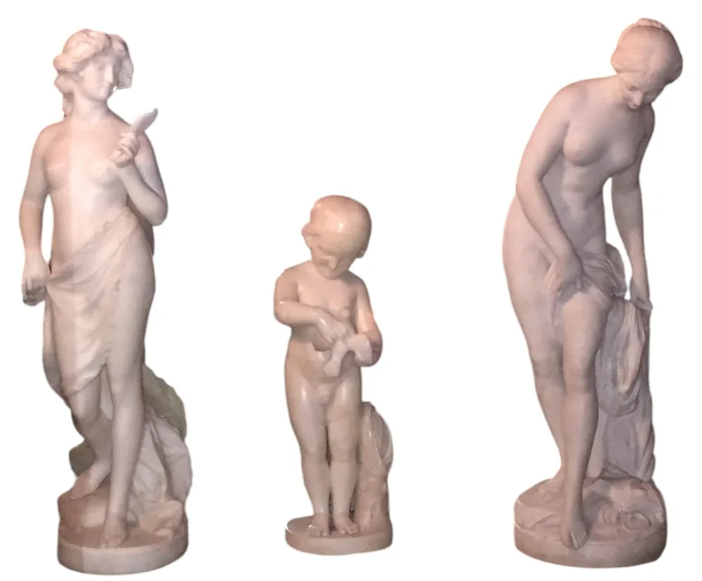 antique sculpture of a child holding a bird
