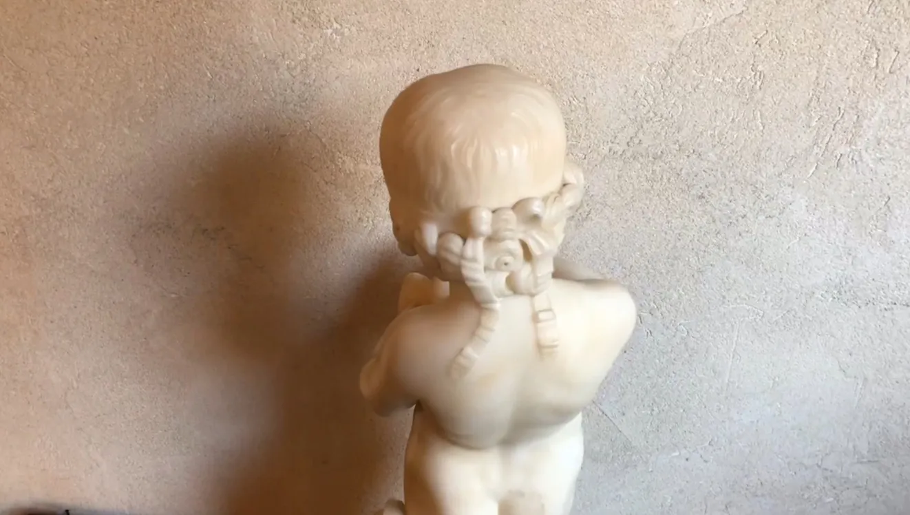 escultura antiga de uma criança segurando um pássaro