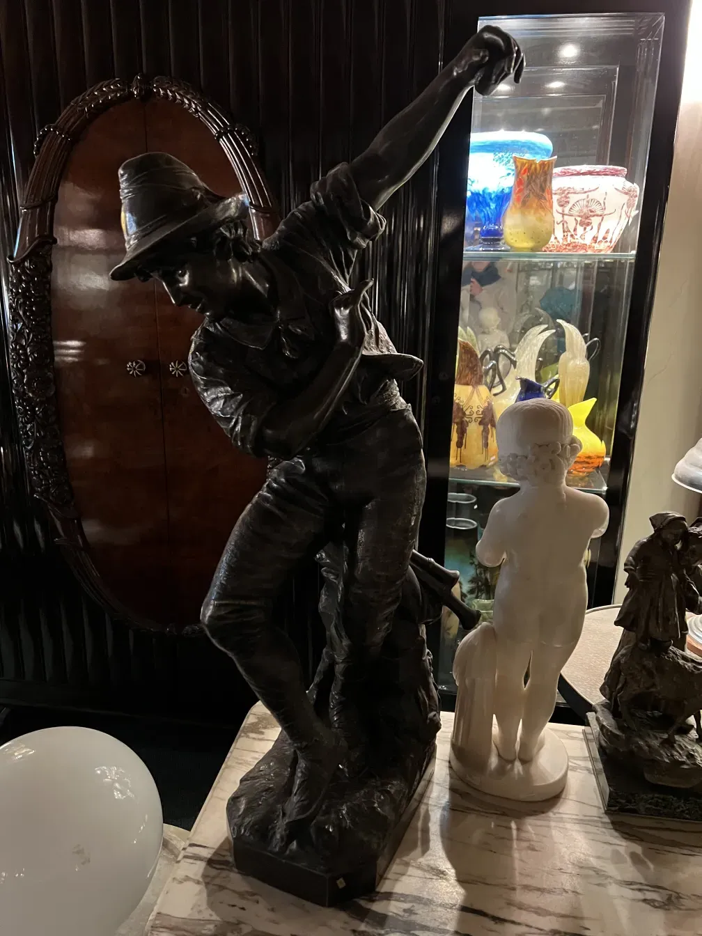 antique sculpture of a child holding a bird