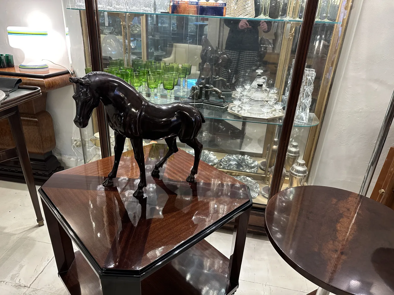 Antique sculpture of a horse with a shiny finish.