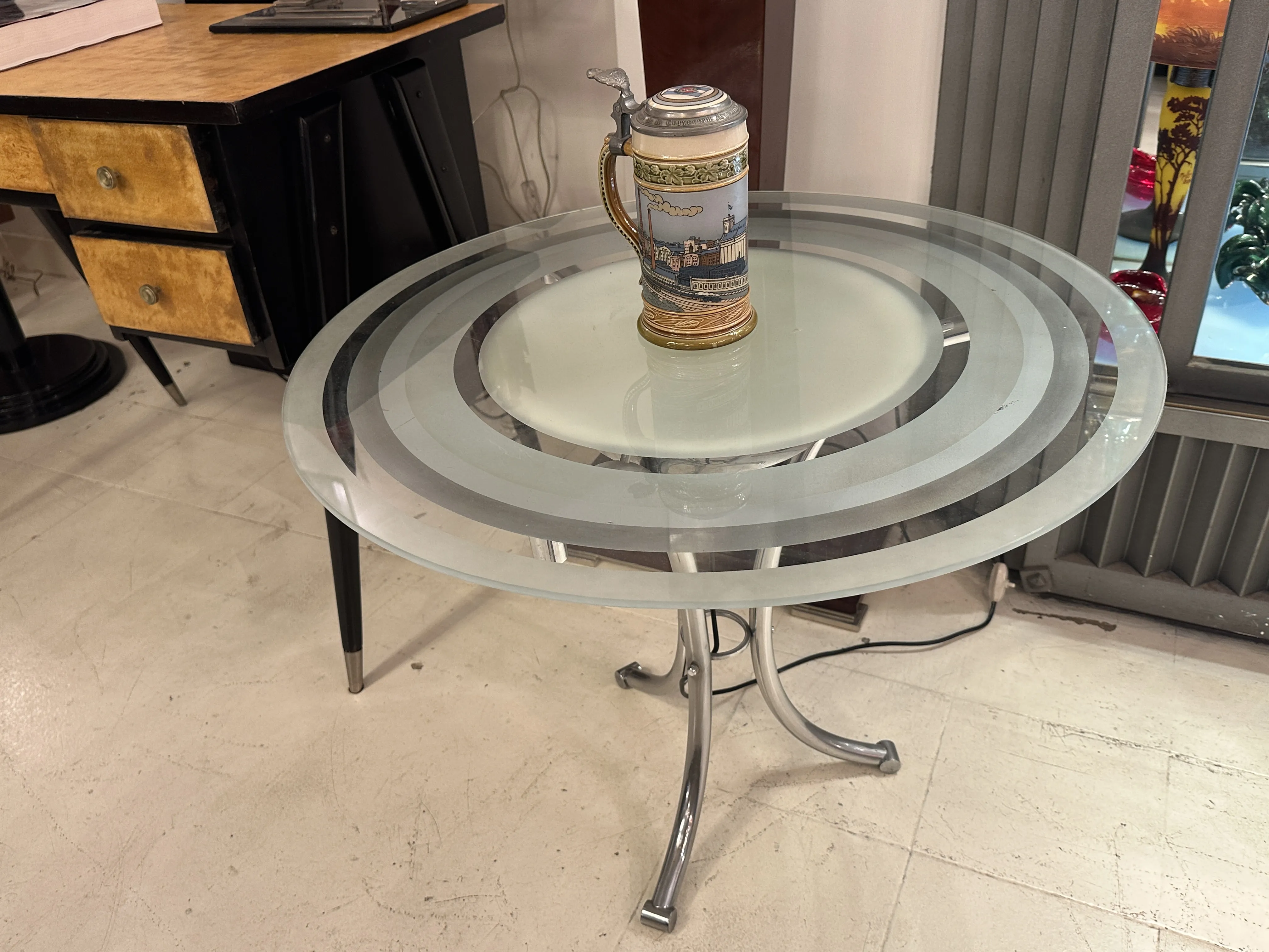 An antique ceramic on a glass table in a modern setting