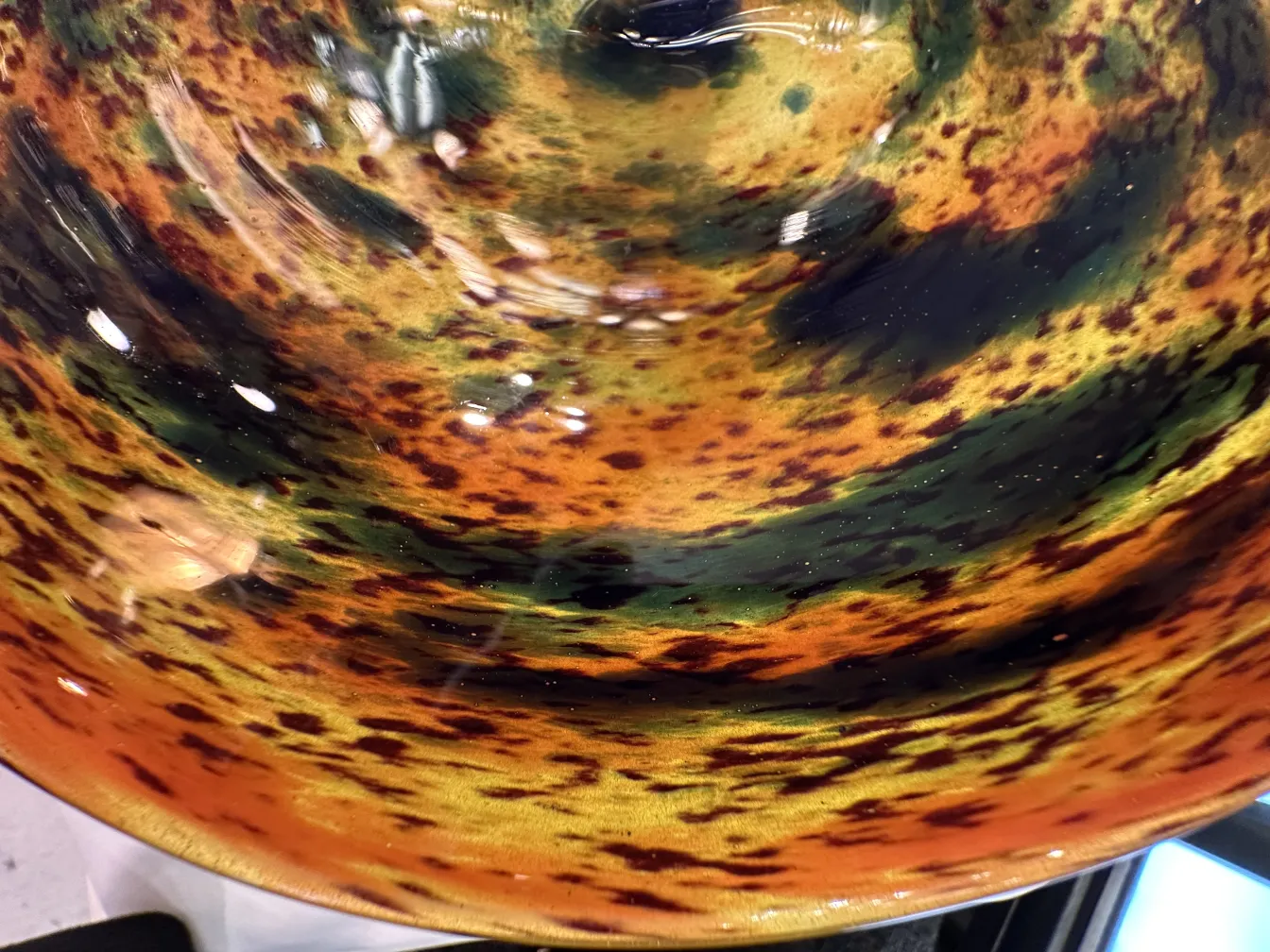 Detail of an elegant signed glass Schneider in vibrant colors