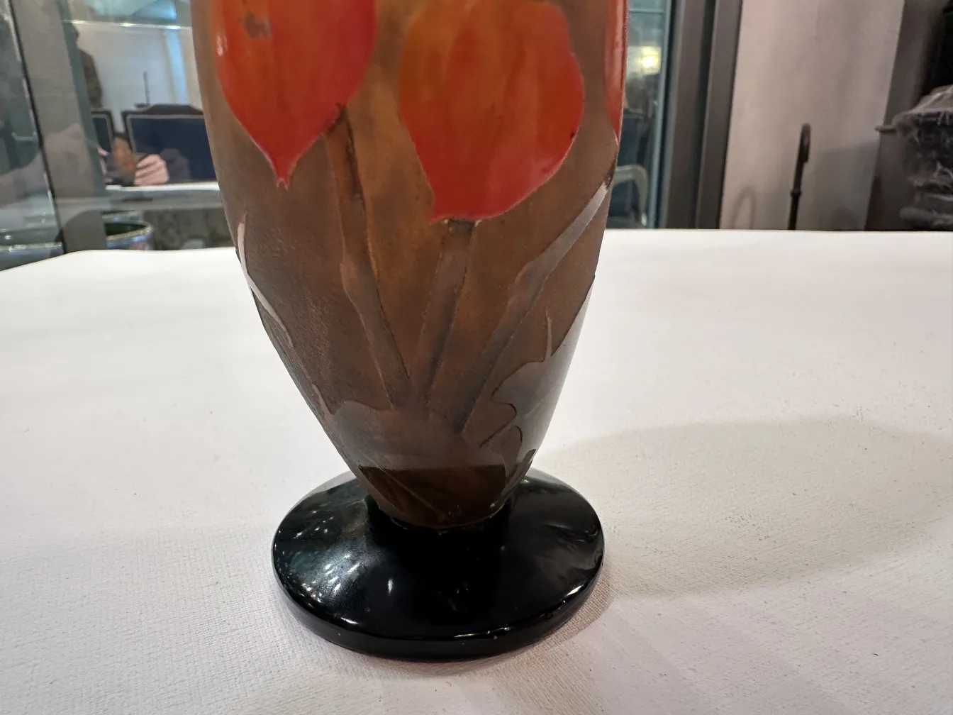 Signed glass Daum Nancy featuring red circular designs.