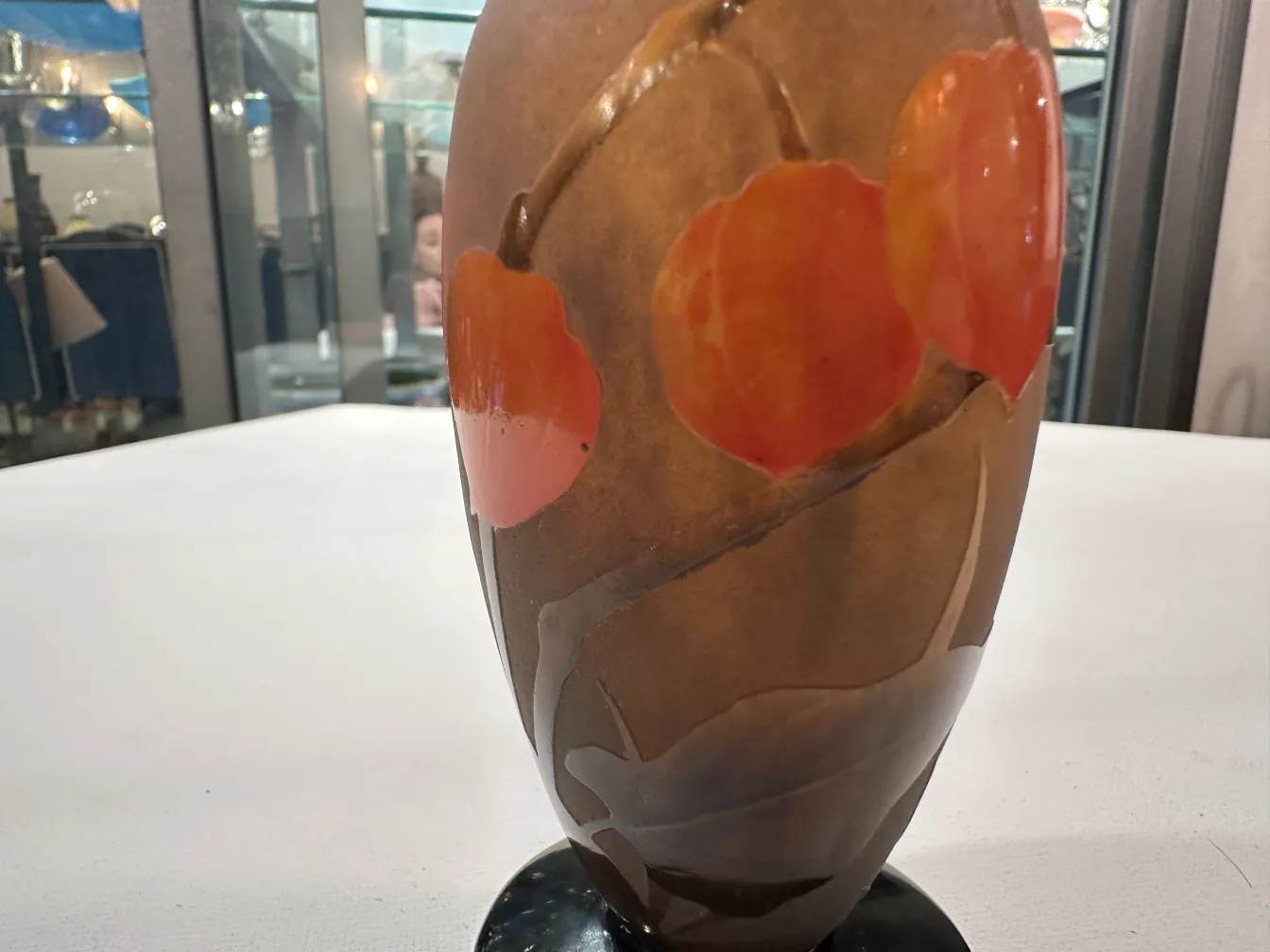 Signed glass Daum Nancy featuring red circular designs.