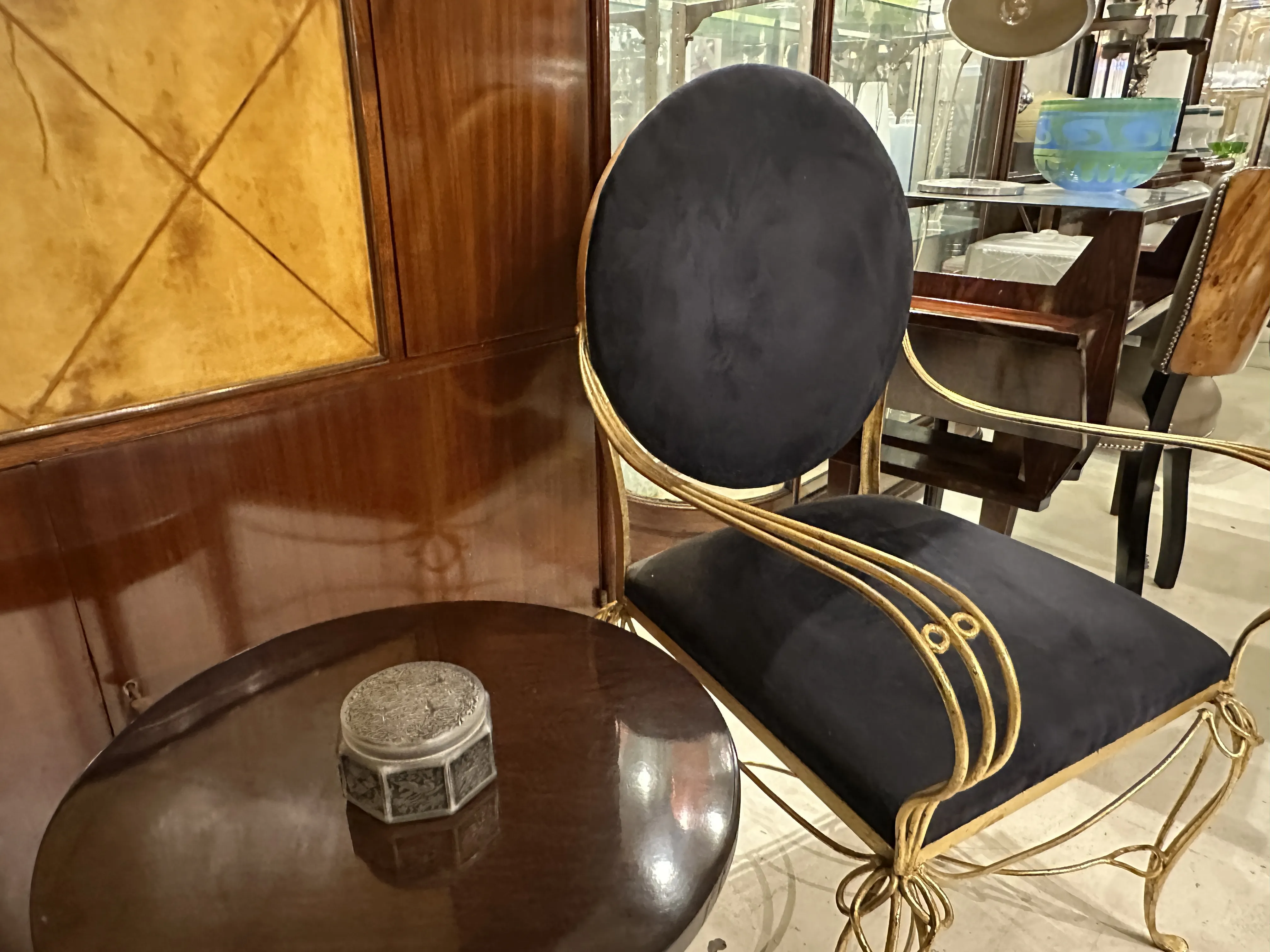 Caja antigua decorativa sobre una mesa oscura junto a una silla elegante