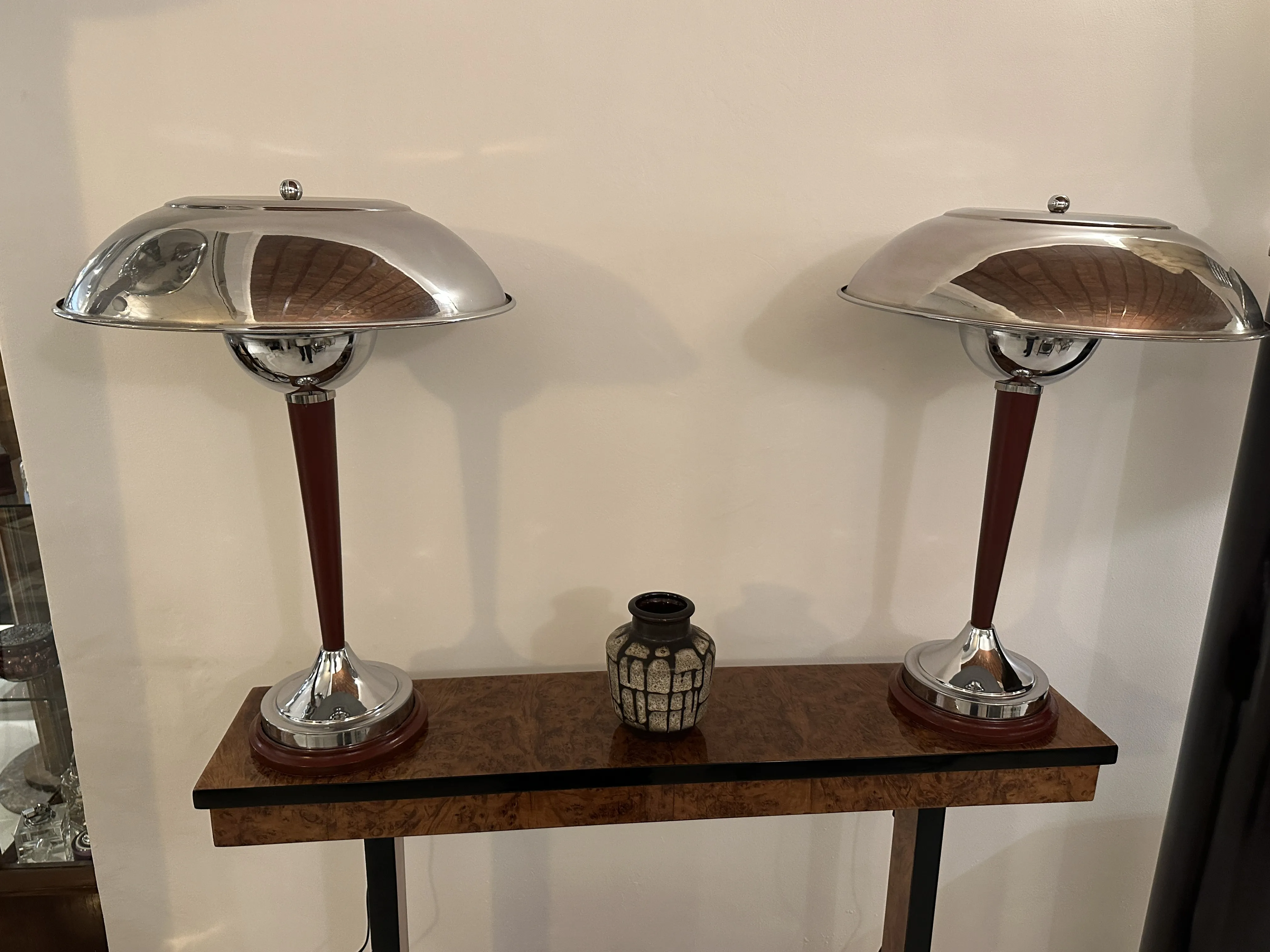 Antique lamps surrounding a decorative ceramic vase.