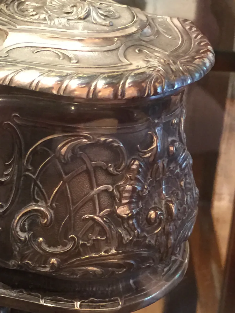 Antique decorative box with intricate engravings and a lid.