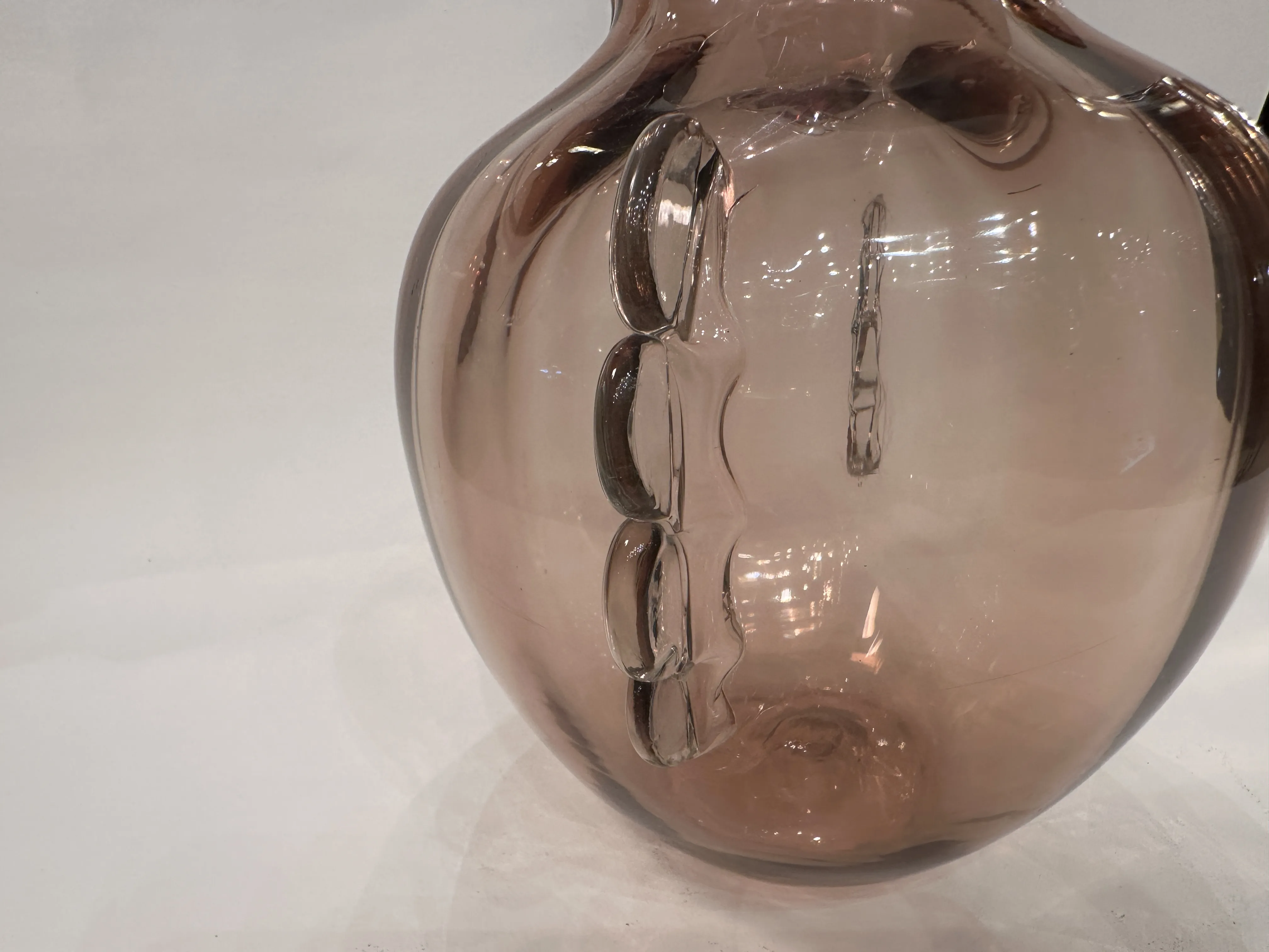 antique murano vase with pink details, elegantly curved, glowing in a bright setting