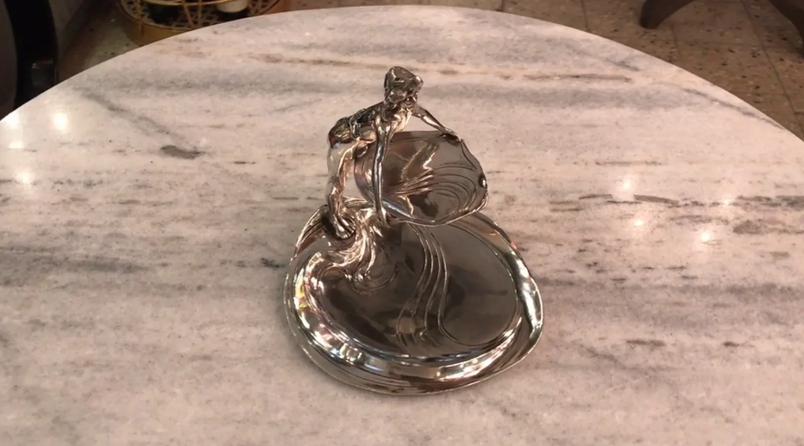 Antique card tray WMF with elegant design on marble tabletop.