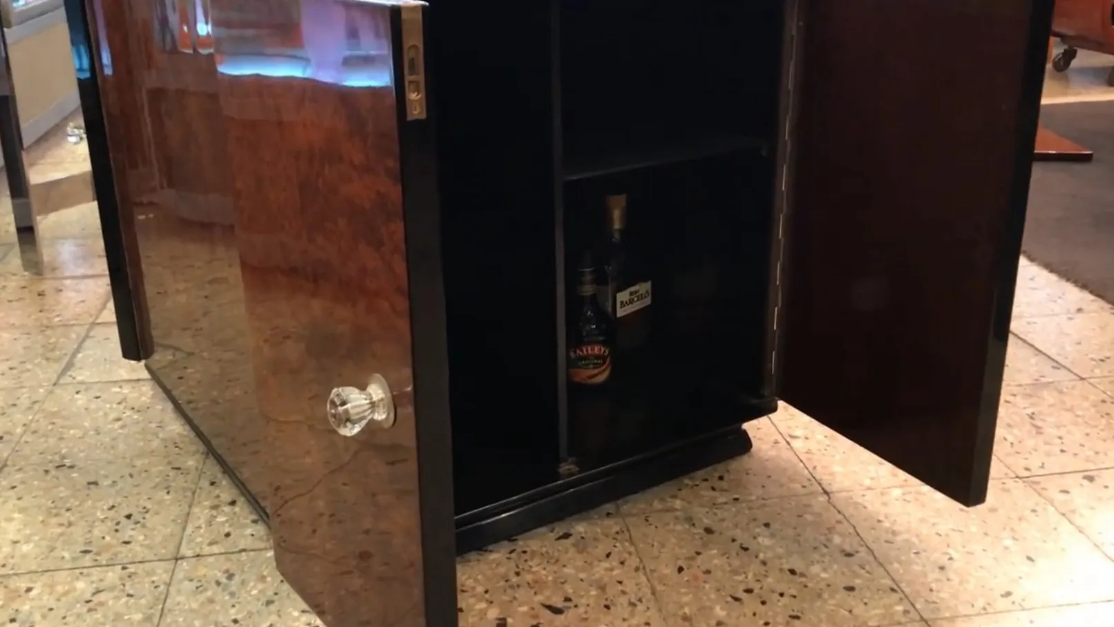 Antique bar with elegant design and internal storage.