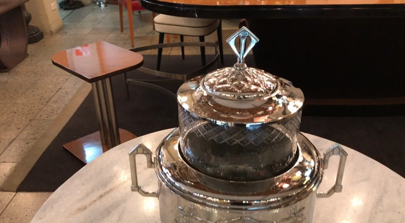 Antique WMF punch bowl with intricate design and crystal lid.
