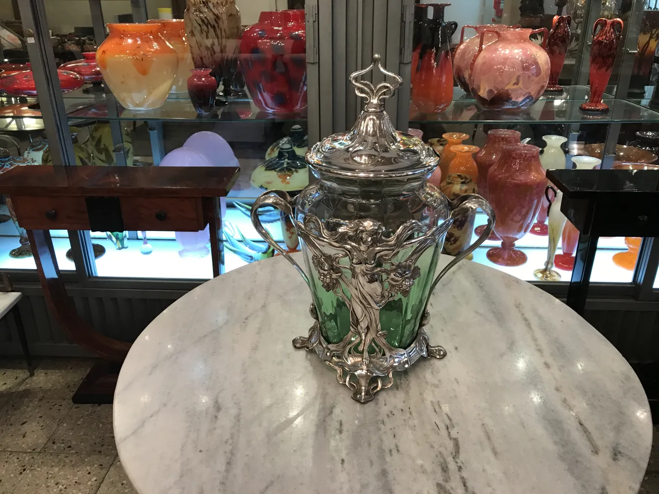 Antique WMF punch bowl with decorative green accents and lid, perfect for displays.