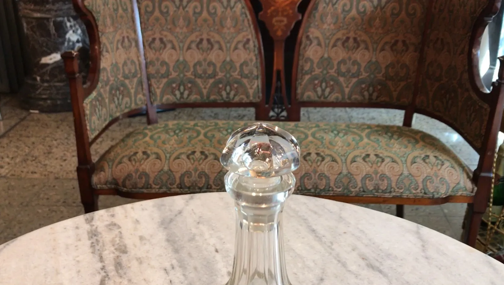 antique glass bottle with glass stopper, marble table background