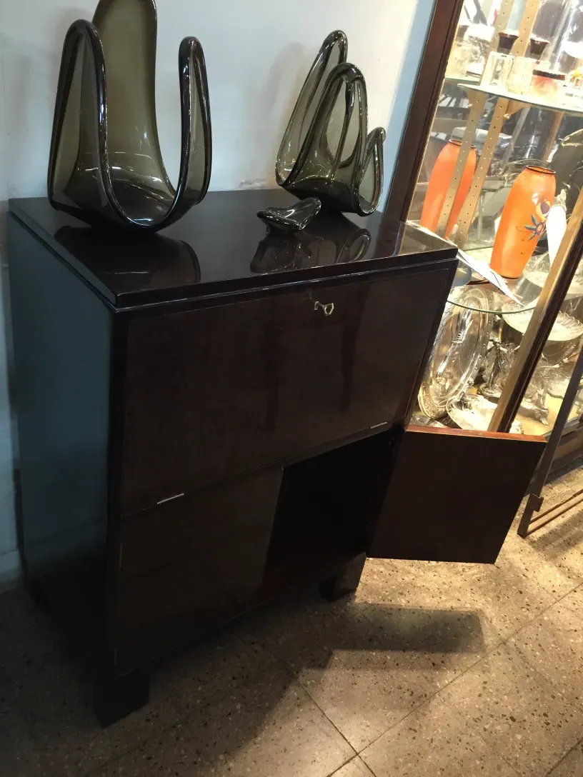 Antique bar cabinet with ornate details and elegant setting.