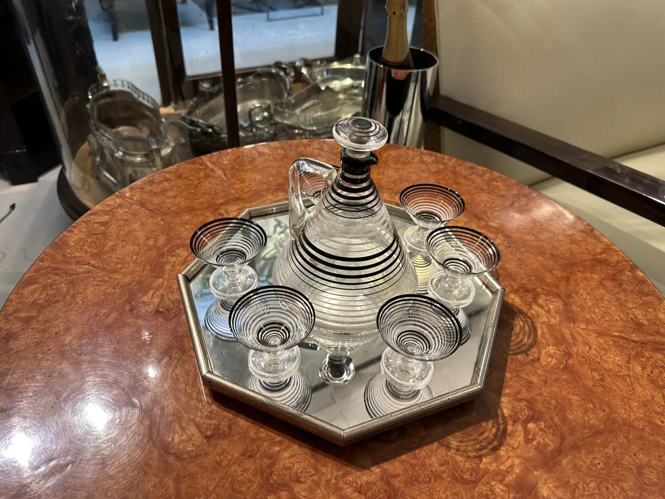 antique liqueur pitcher with 6 glasses on an elegant tray