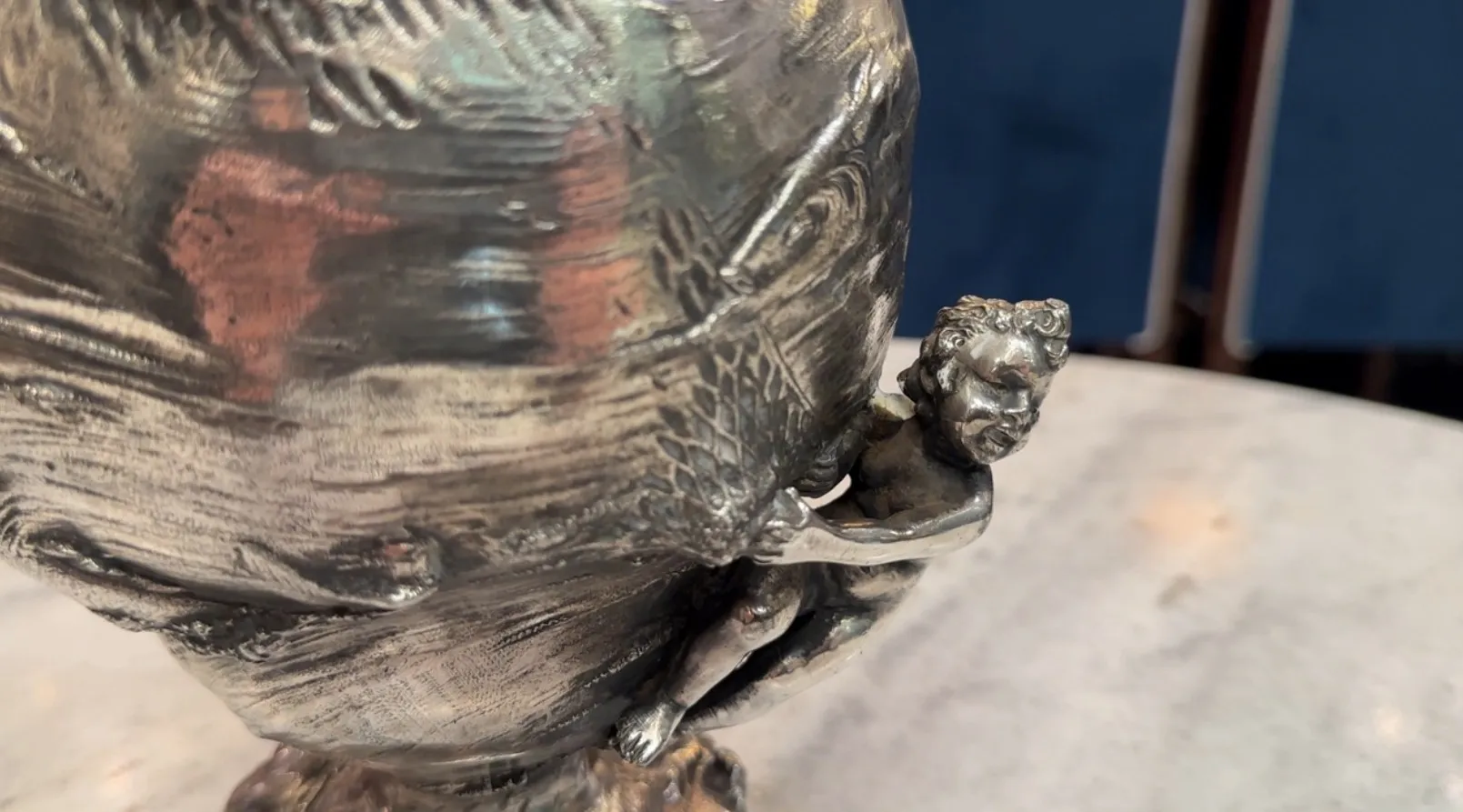 Two antique jars featuring a decorative figure and intricate details.