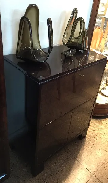 Mueble bar antiguo de madera con dos cajones y decoraciones elegantes.