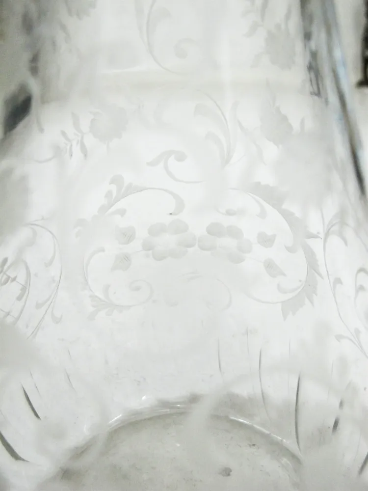 two antique WMF jars with intricate design and decorative handles, in an elegant setting