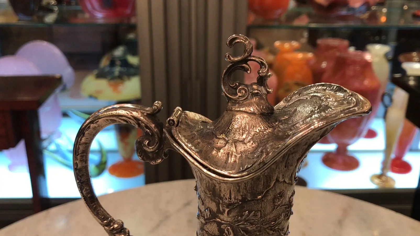 two antique WMF jars with intricate design and decorative handles, in an elegant setting