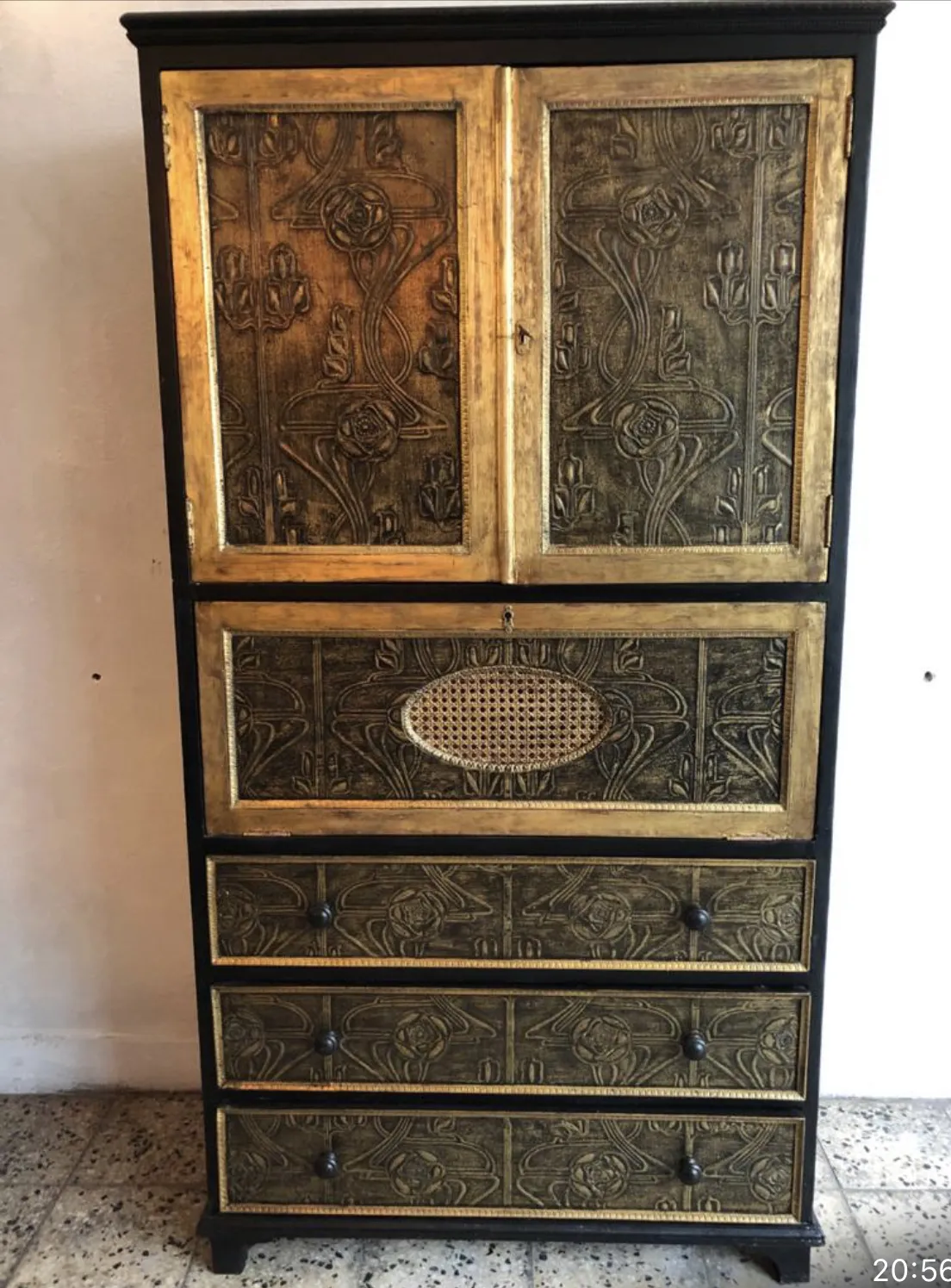 Antique bar cabinet with golden and black details, stylish design.