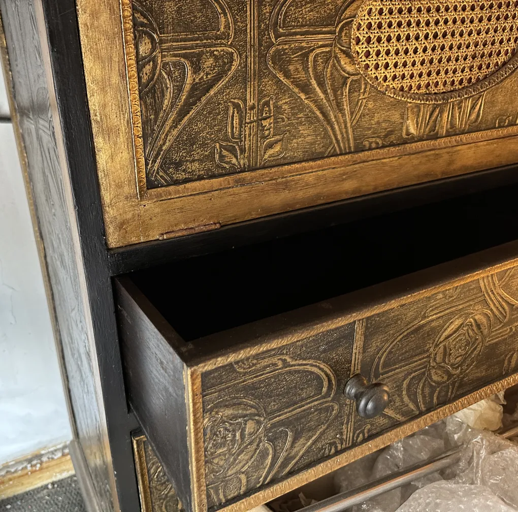 Antique bar with detailed rose design, placed in an elegant setting.